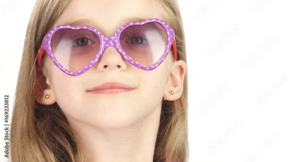 Child posing for video cameras with glasses. White background. Close up Child posing for video cameras with glasses. White background. Close up