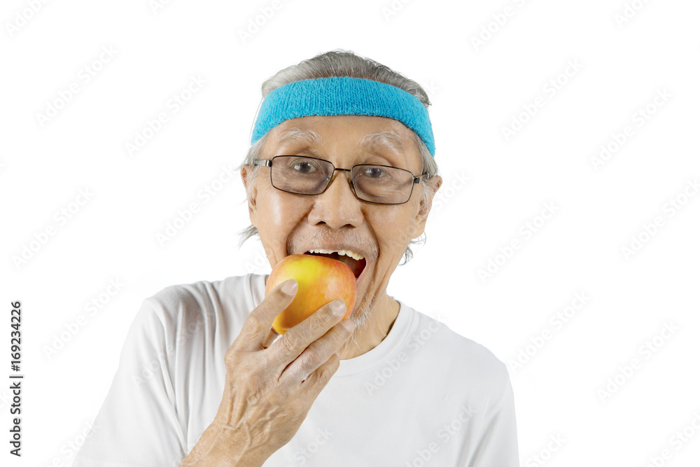 Old man eating an organic apple