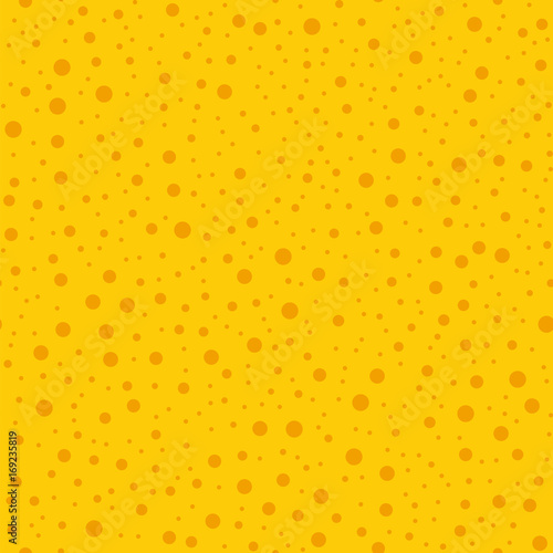 Orange polka dots seamless pattern on yellow background. Overwhelming classic orange polka dots textile pattern in restrained colours. Seamless scattered confetti fall chaotic decor.