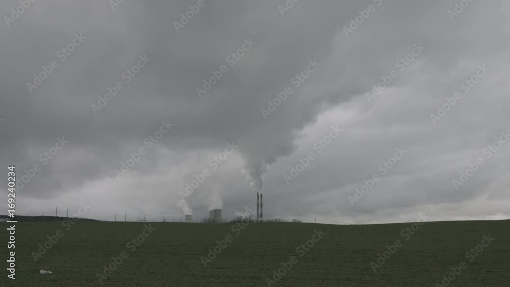 Timelapse of the polluting power plant with heavy clouds of wastes near natural field Timelapse of the polluting power plant with heavy clouds of wastes near natural field