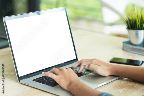 hand typing laptop computer showing blank screen on table office place