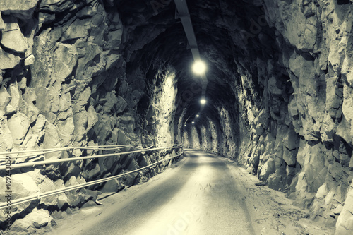 dark tunnel in the mountains with dramatic illumination