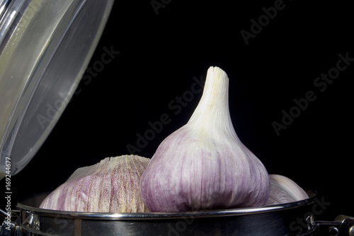 Garlic in a metal container photo