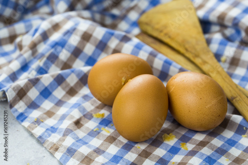 eggs, towel and kitchen tools on wooden table