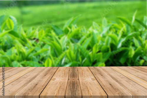Empty light wood table top with tea fied background. Leave space for placement you background - can be used for display or montage or mock up your products.