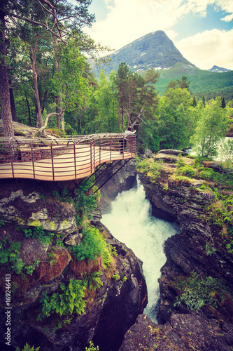 Tourist with camera on Gudbrandsjuvet waterfall, Norway photo