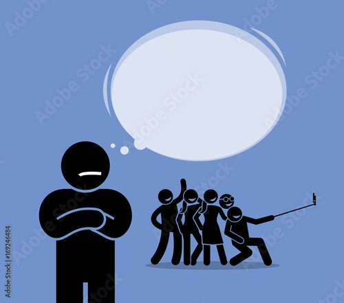 Antisocial or Anti-Social. A man looking at a group of friends having fun but do not want to join them. He prefers to be alone and dislike mingling around.