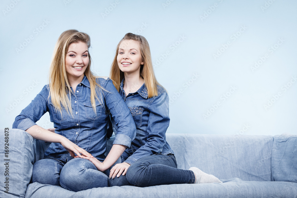 Two happy women friends wearing jeans outfit Two happy women friends wearing jeans outfit
