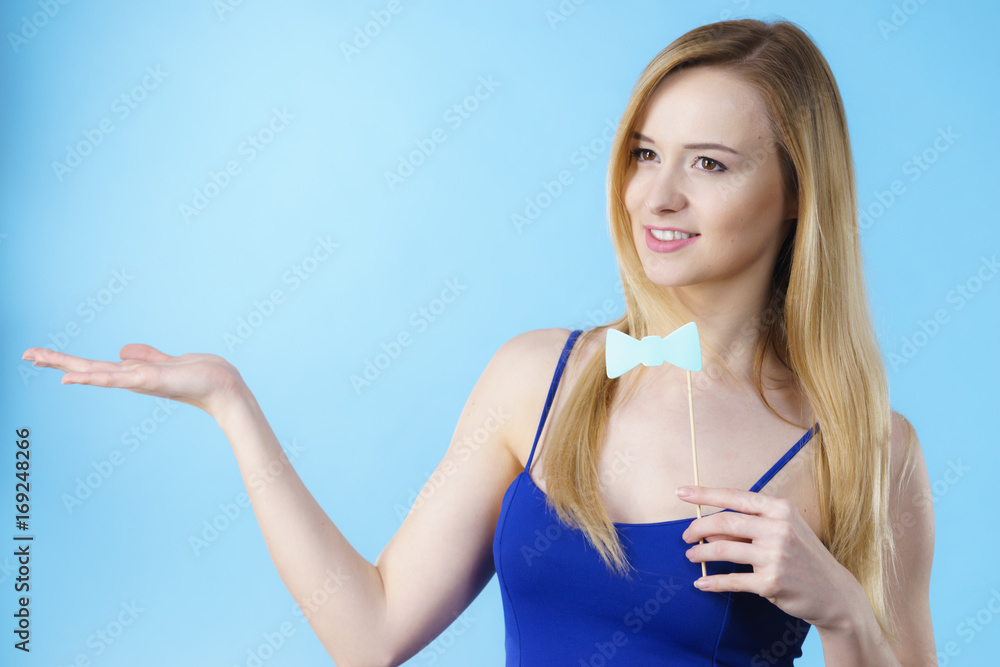 Woman holding carnival accessories on stick Woman holding carnival accessories on stick
