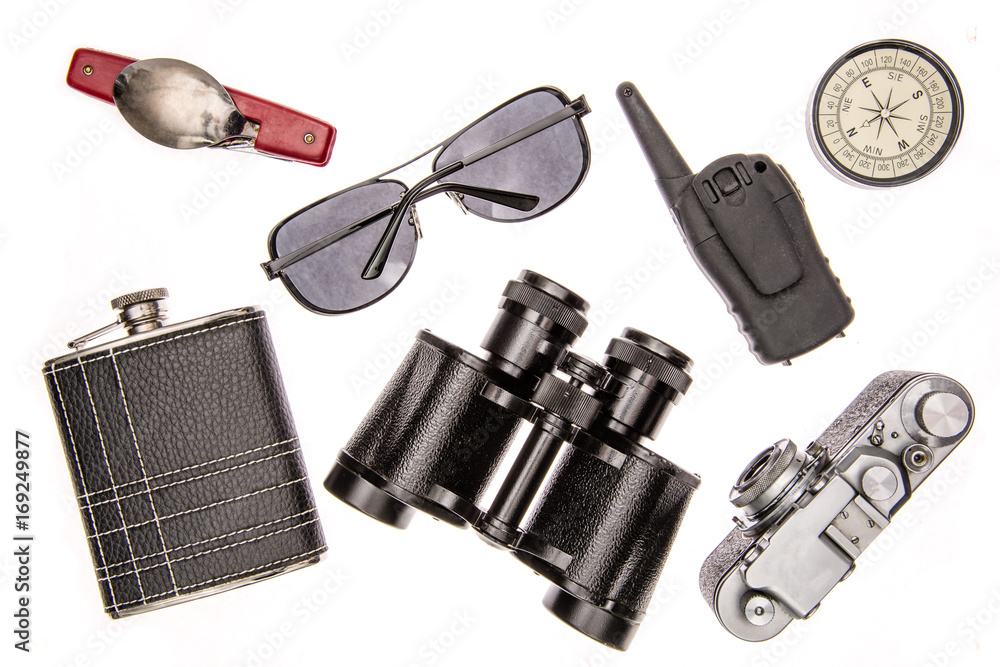 Items for travel: compass, camera, glasses, walkie-talkie, binoculars, flask, folding knife with a spoon and fork. Items for travel: compass, camera, glasses, walkie-talkie, binoculars, flask, folding knife with a spoon and fork.