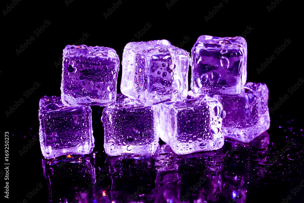 Purple ice cubes on a black table. Purple ice cubes on a black table.