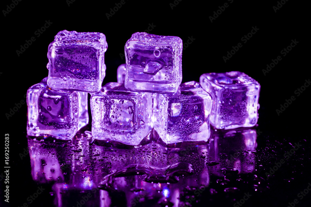 Purple ice cubes on a black table. Purple ice cubes on a black table.