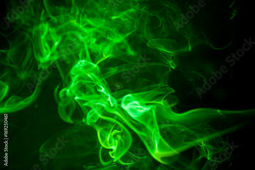 Green smoke motion on black background.