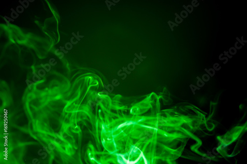 Green smoke motion on black background.
