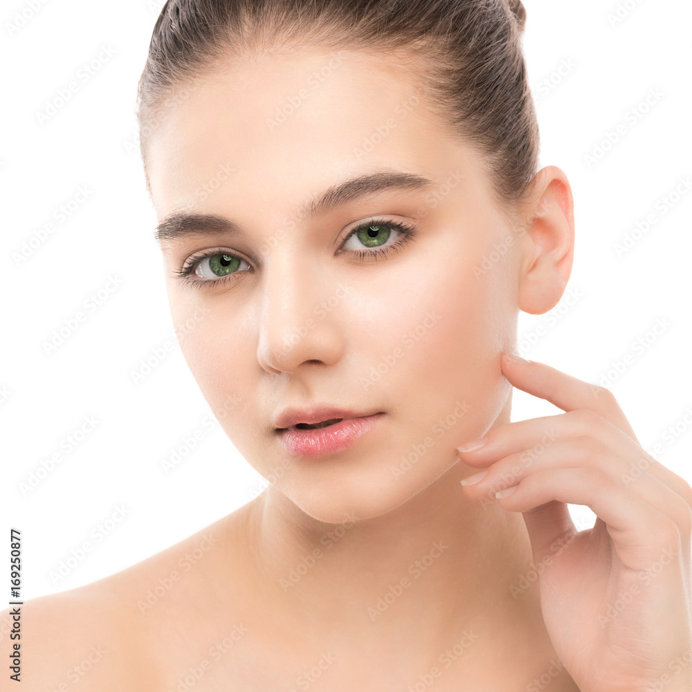 Portrait of beautiful young brunette woman with clean face. Beauty spa model girl with perfect fresh clean skin. Looking at camera and smiling. Youth and skin care concept. Isolated on a white