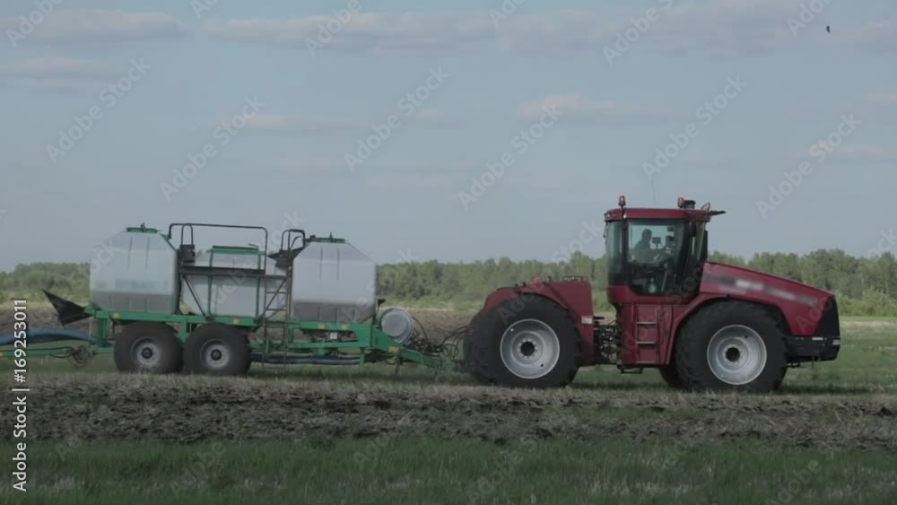 Agricultural tractor sowing and cultivating field Agricultural tractor sowing and cultivating field