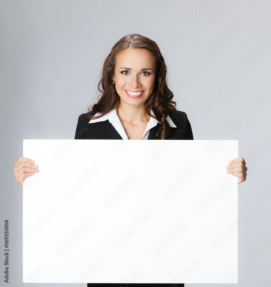 Businesswoman showing signboard, over grey Businesswoman showing signboard, over grey