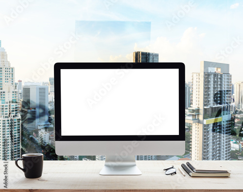 desktop computer white frame on work table in office place city background