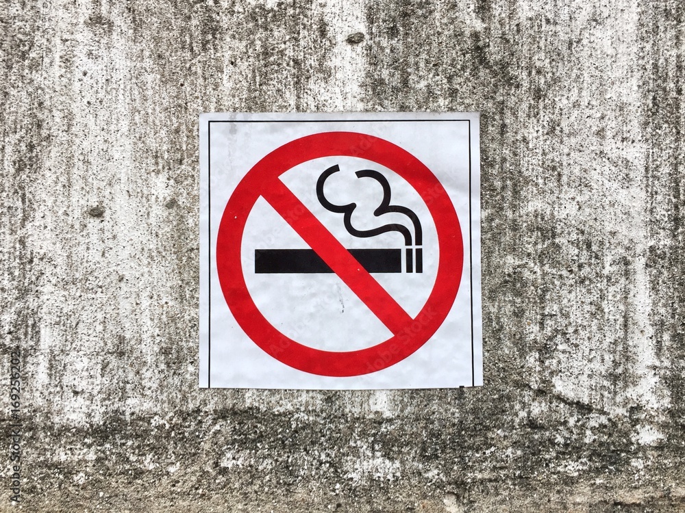 No smoking sign on concrete wall background No smoking sign on concrete wall background