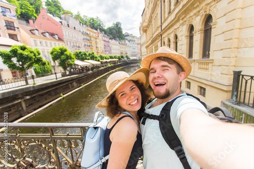 Photography Handsome couple taking selfie with mobile smart phone camera in european city