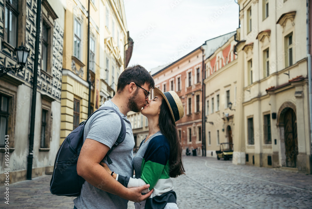 man with woman kissing outside