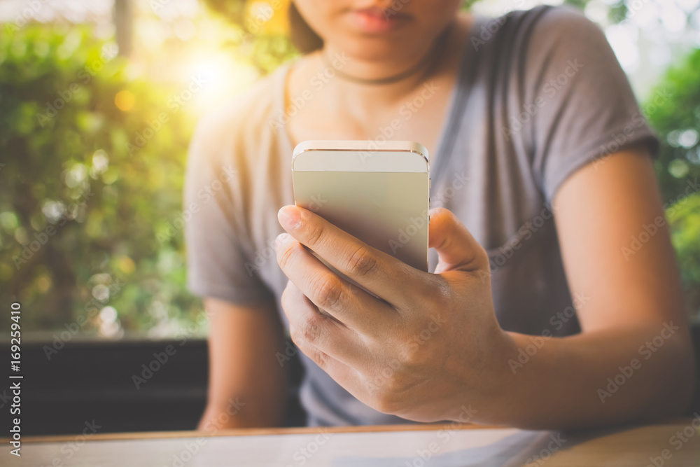 Asian woman hand holding mobile phone and using application on smartphone Asian woman hand holding mobile phone and using application on smartphone
