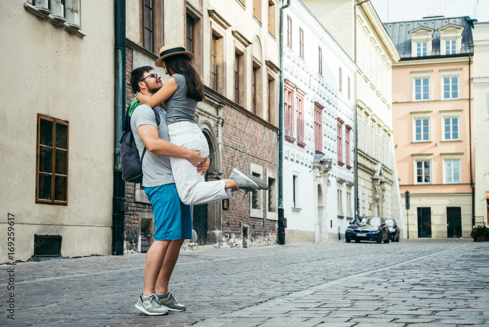 man hold woman on the street of old european city