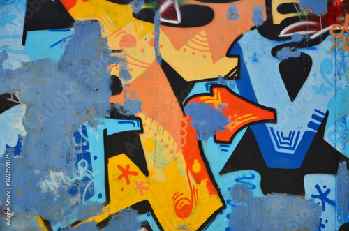 The old wall, painted in color graffiti drawing blue aerosol paints. Background image on the theme of drawing graffiti and street art