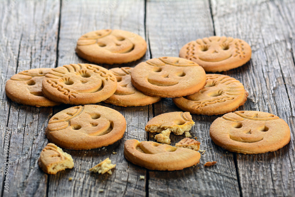 Funny face cookies on wooden background