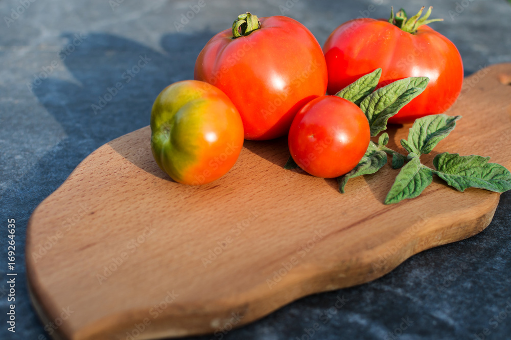 Yellow and red tomatoes on the board Yellow and red tomatoes on the board