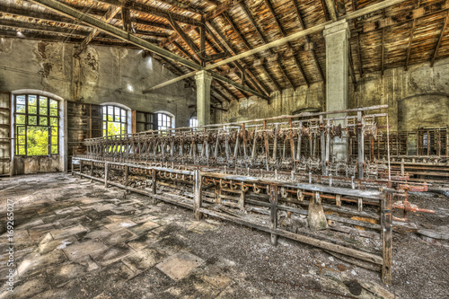 Old weaving looms and spinning machinery at an abandoned factory