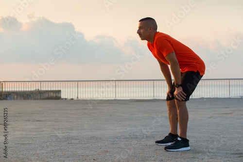 Quadro em tela Serious athlete recovering breath after jogging