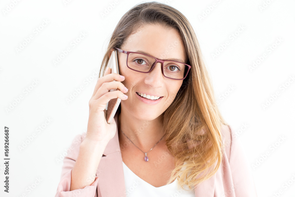 Smiling young businesswoman talking on phone Smiling young businesswoman talking on phone