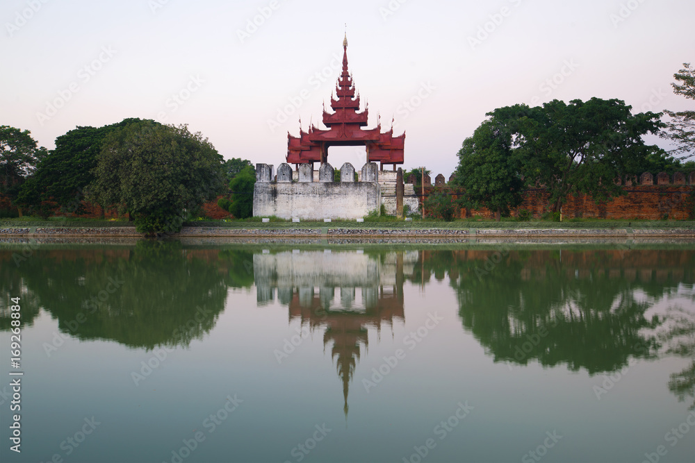 Ancient bastion of the old city with reflection in gray twilight. Mandalay, Burma (Myanmar) Ancient bastion of the old city with reflection in gray twilight. Mandalay, Burma (Myanmar)