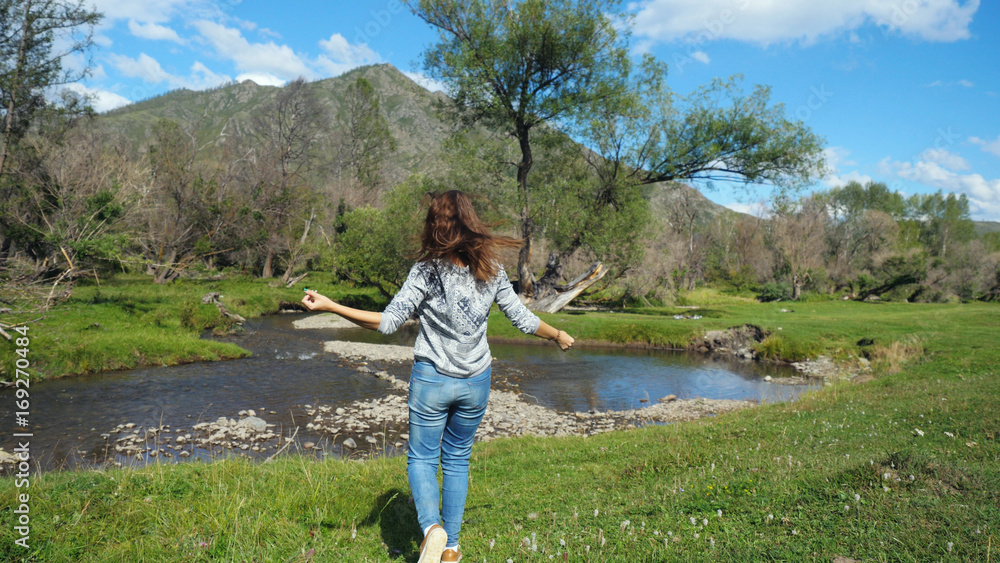 Hiking woman walking alone in beautiful landscape nature.