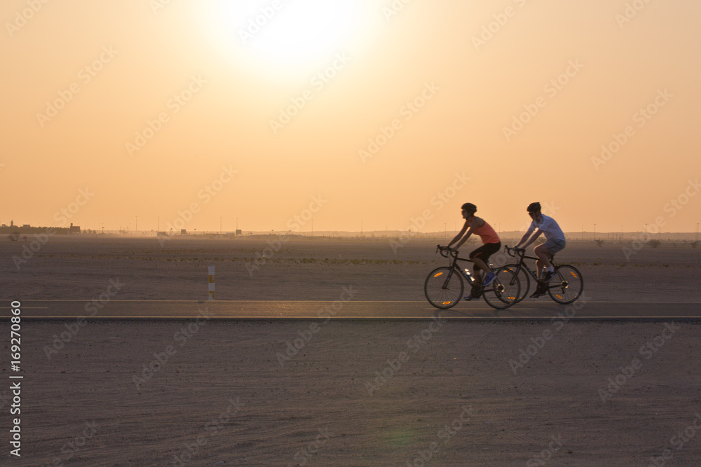 Cycling in the desert at sunset