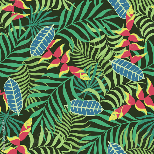 Tropical background with palm leaves and flowers. Seamless floral pattern