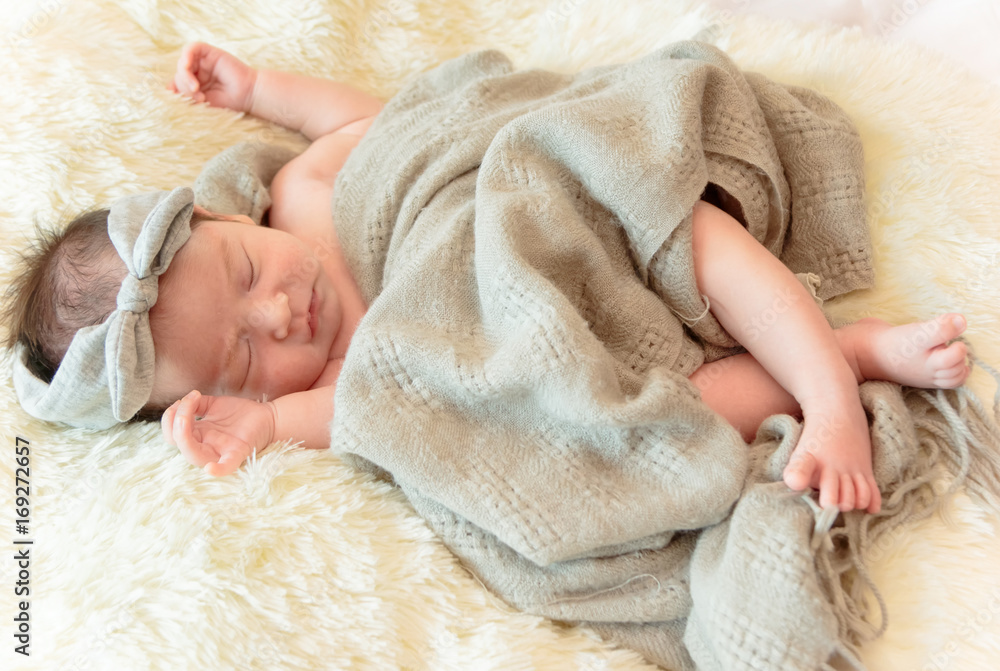 Newborn baby girl is sleeping on fur blanket Newborn baby girl is sleeping on fur blanket
