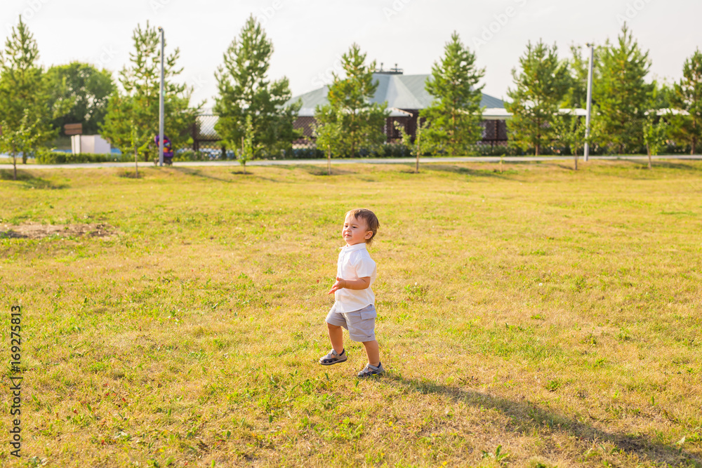 Smiling happy baby boy on natural background in summer or autumn Smiling happy baby boy on natural background in summer or autumn