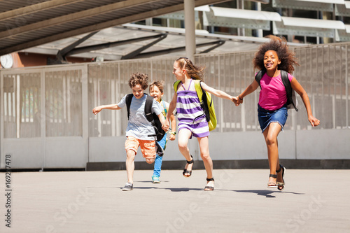 School mates run after class together and happy