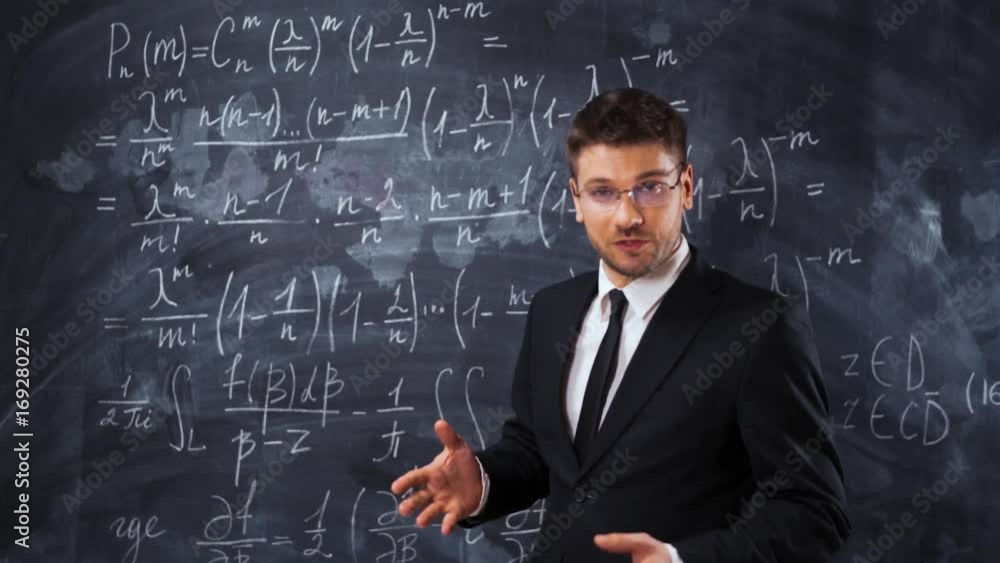 Young handsome male teacher or student in spectacles explaining decision of hard math equation. He prove the theorem and want to invite You to study in university. 4k UHD Young handsome male teacher or student in spectacles explaining decision of hard math equation. He prove the theorem and want to invite You to study in university. 4k UHD