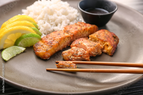 Delicious roasted salmon fillets with rice on plate