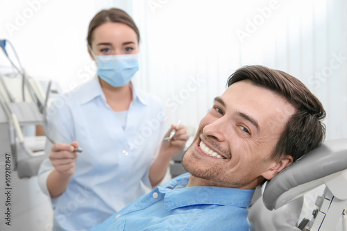 Handsome man at dentist's o...