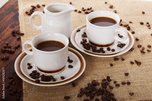 cups of coffee and milk and roasted coffee beans