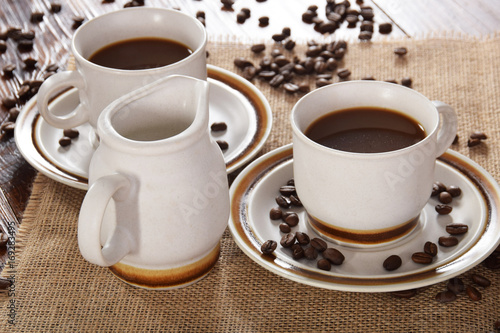 cups of coffee and milk and roasted coffee beans