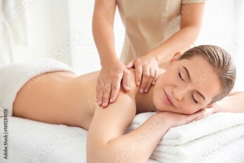 Young beautiful woman having massage in spa salon