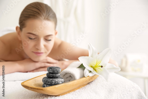Spa set in salon with blurred woman on background