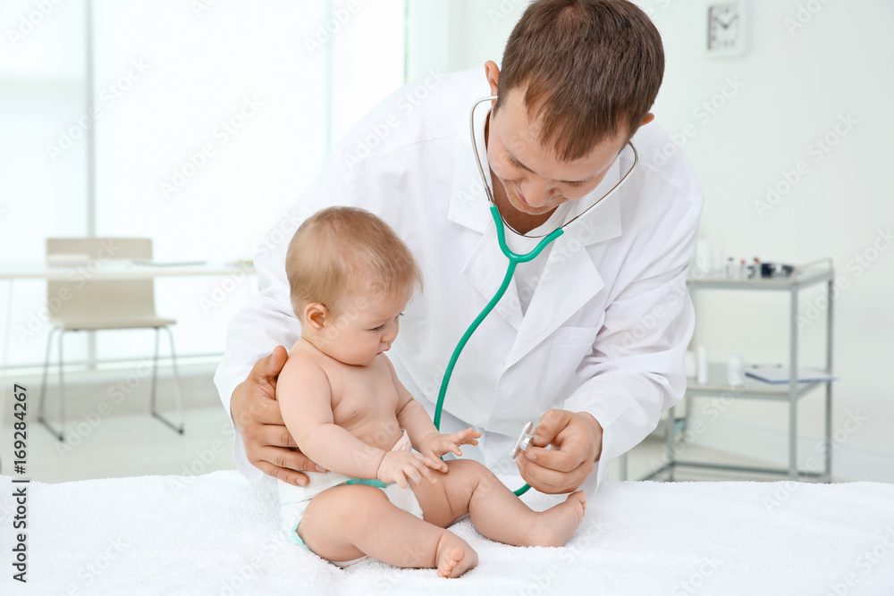 Doctor examining baby patient with stethoscope Doctor examining baby patient with stethoscope