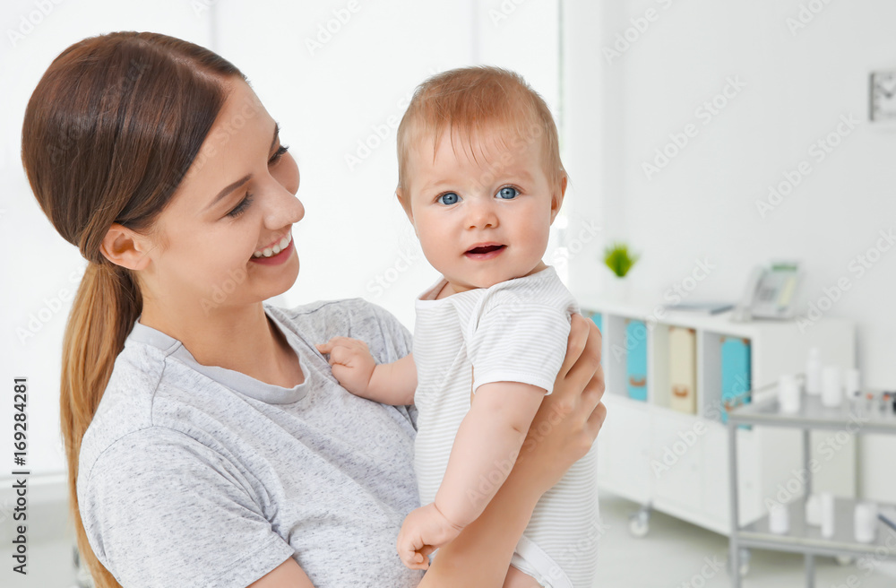Young mother and baby girl in doctor's office Young mother and baby girl in doctor's office