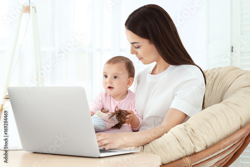 Young mother holding baby w...